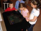 Kids Playing on Cocktail Arcade